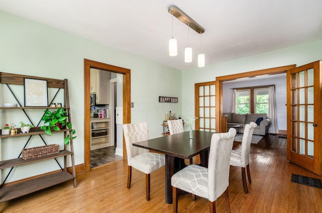 138 E Kelso Rd, Columbus, OH 43202 - dining area with french doors, wood finished floors, and baseboards