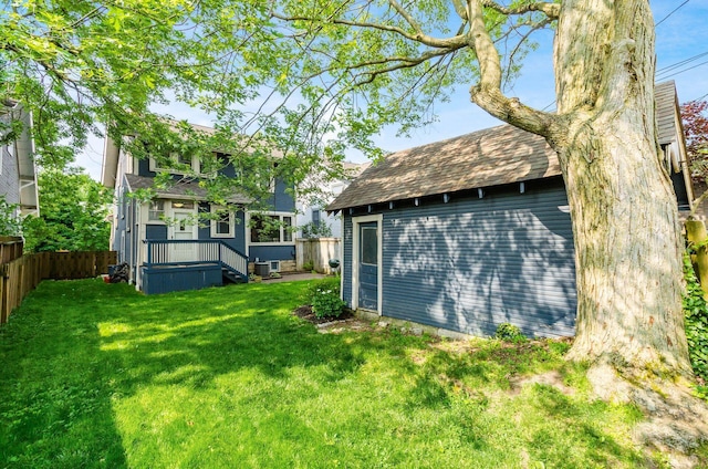 138 E Kelso Rd, Columbus, OH 43202 - rear view of property featuring central AC, a shingled roof, and an outbuilding