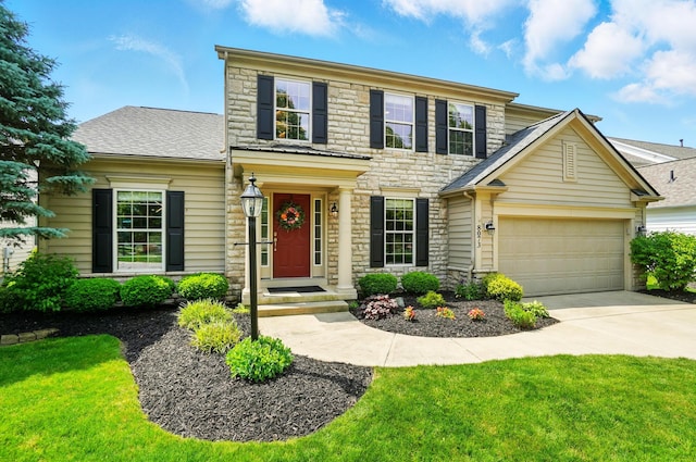 8073 Tree Lake Blvd, Powell, OH 43065 - view of front facade featuring stone siding, a garage, concrete driveway, and a front lawn
