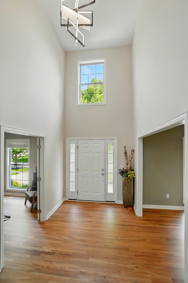 8073 Tree Lake Blvd, Powell, OH 43065 - entryway featuring high vaulted ceiling, a chandelier, and light wood-style floors