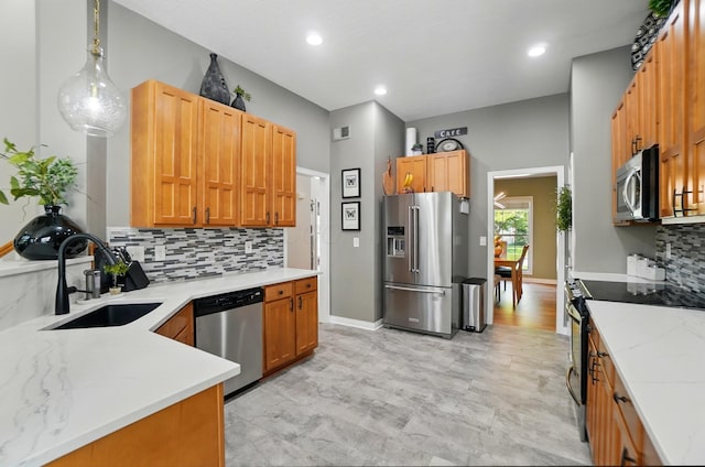 8073 Tree Lake Blvd, Powell, OH 43065 - kitchen featuring appliances with stainless steel finishes, backsplash, light stone counters, pendant lighting, and recessed lighting