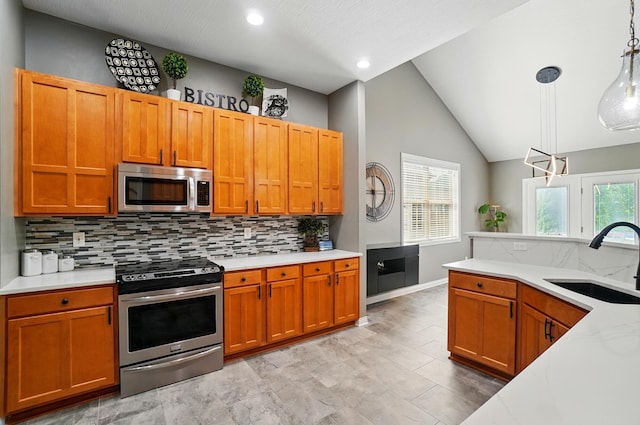 8073 Tree Lake Blvd, Powell, OH 43065 - kitchen with stainless steel appliances, backsplash, hanging light fixtures, lofted ceiling, and brown cabinets