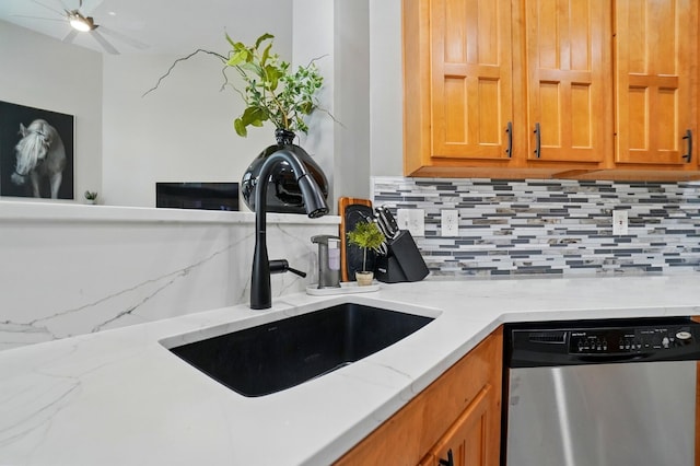 8073 Tree Lake Blvd, Powell, OH 43065 - kitchen featuring stainless steel dishwasher, decorative backsplash, brown cabinetry, and light stone countertops