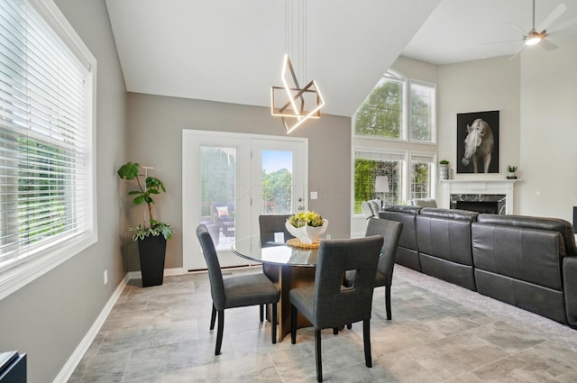 8073 Tree Lake Blvd, Powell, OH 43065 - dining space with healthy amount of natural light, a premium fireplace, ceiling fan, and a towering ceiling