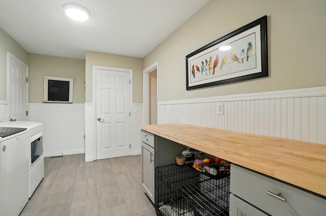 8073 Tree Lake Blvd, Powell, OH 43065 - kitchen with butcher block countertops, wainscoting, washing machine and clothes dryer, and gray cabinets