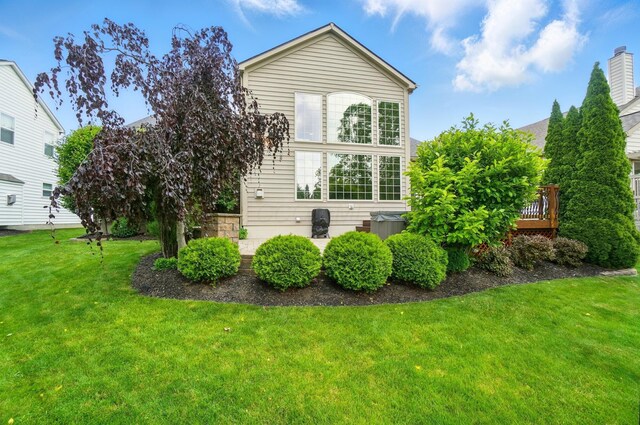 8073 Tree Lake Blvd, Powell, OH 43065 - view of side of home with a lawn and a wooden deck