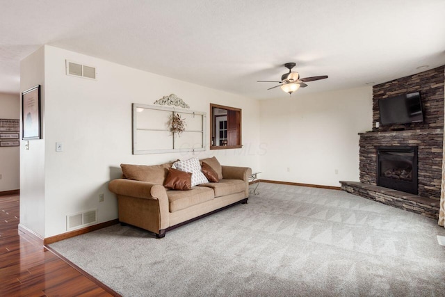 1875 Madden Higgins Rd, London, OH 43140 - living area featuring baseboards, a ceiling fan, a fireplace, and wood finished floors