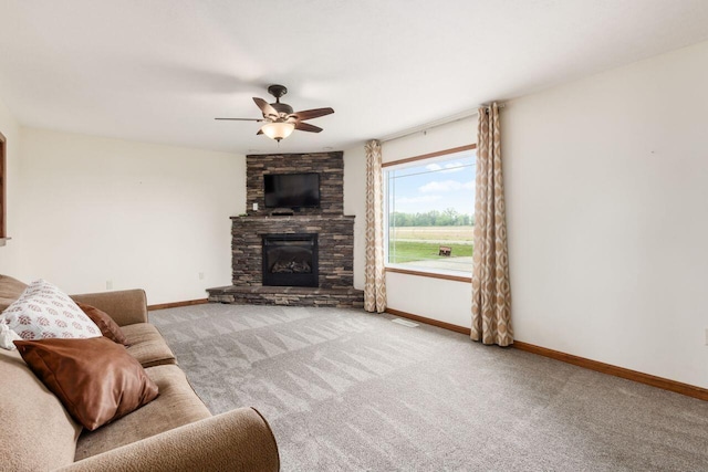1875 Madden Higgins Rd, London, OH 43140 - carpeted living room featuring baseboards, ceiling fan, and a fireplace
