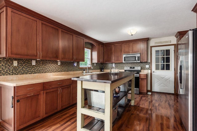 1875 Madden Higgins Rd, London, OH 43140 - kitchen with appliances with stainless steel finishes, dark wood-type flooring, decorative backsplash, and a sink