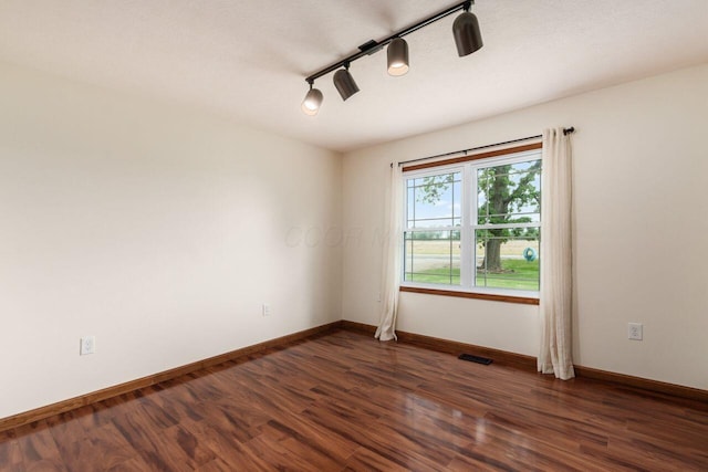 1875 Madden Higgins Rd, London, OH 43140 - spare room with dark wood-style floors, baseboards, and track lighting