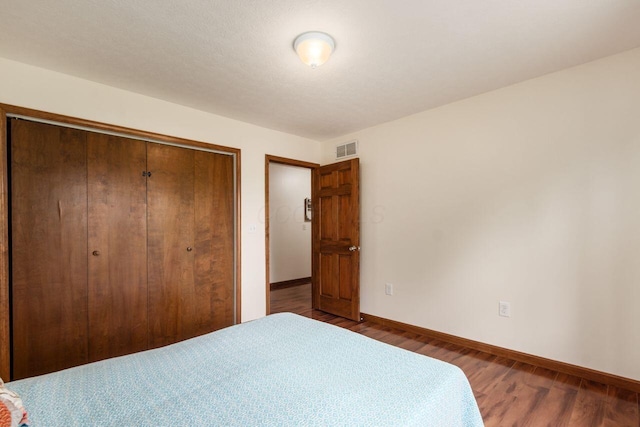 1875 Madden Higgins Rd, London, OH 43140 - bedroom featuring a closet, baseboards, and wood finished floors
