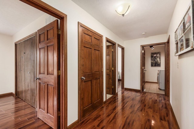 1875 Madden Higgins Rd, London, OH 43140 - hallway featuring dark wood-style flooring, washer / dryer, and baseboards