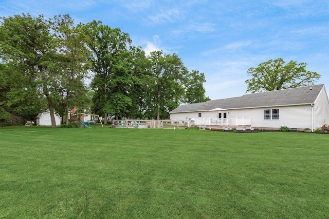 1875 Madden Higgins Rd, London, OH 43140 - view of grassy yard featuring a playground and a deck