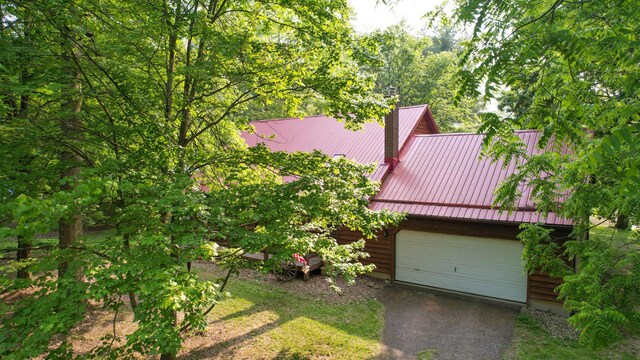 5467 Timpson Rd, Caledonia, OH 43314 - view of side of home with metal roof and asphalt driveway