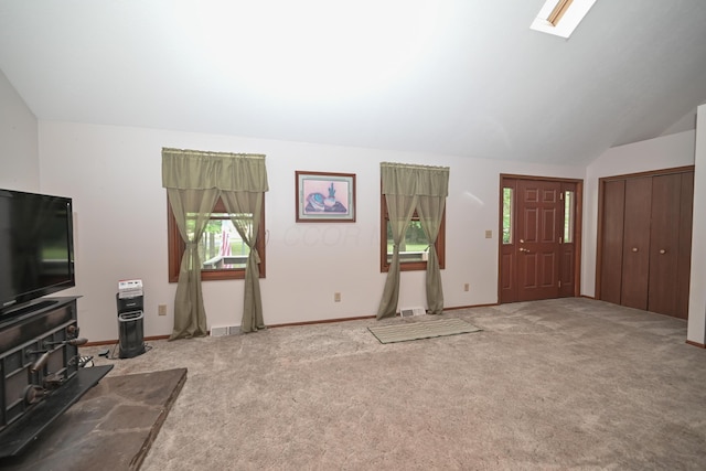 5467 Timpson Rd, Caledonia, OH 43314 - carpeted entrance foyer with healthy amount of natural light, vaulted ceiling, a wood stove, and baseboards