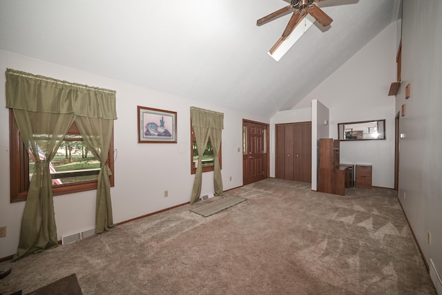 5467 Timpson Rd, Caledonia, OH 43314 - unfurnished living room featuring ceiling fan, carpet floors, high vaulted ceiling, baseboards, and a skylight