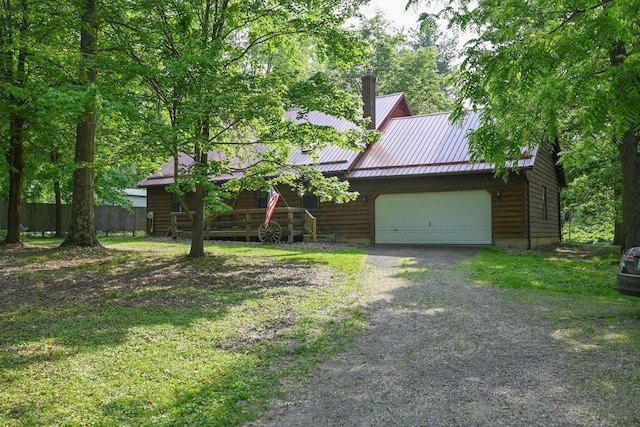 5467 Timpson Rd, Caledonia, OH 43314 - view of front facade featuring metal roof, a garage, gravel driveway, and a chimney