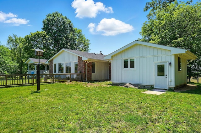 5350 Brook Rd NW, Lancaster, OH 43130 - rear view of house with board and batten siding and a yard