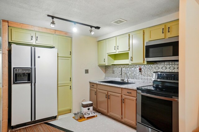 5350 Brook Rd NW, Lancaster, OH 43130 - kitchen with appliances with stainless steel finishes, a sink, light countertops, decorative backsplash, and rail lighting