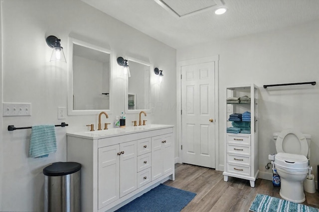 5350 Brook Rd NW, Lancaster, OH 43130 - bathroom with toilet, double vanity, wood finished floors, and baseboards
