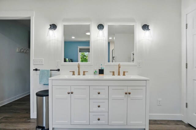 5350 Brook Rd NW, Lancaster, OH 43130 - bathroom featuring double vanity, wood finished floors, and baseboards