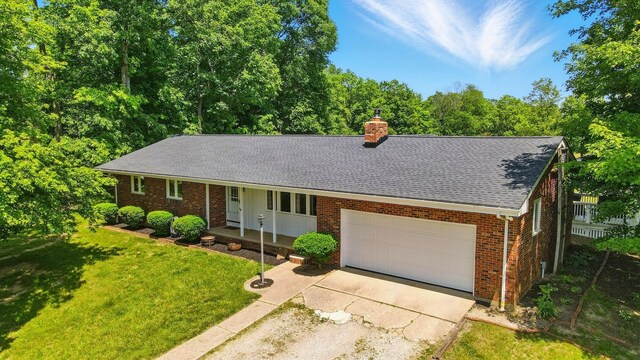 5350 Brook Rd NW, Lancaster, OH 43130 - single story home with a shingled roof, a chimney, brick siding, covered porch, and an attached garage