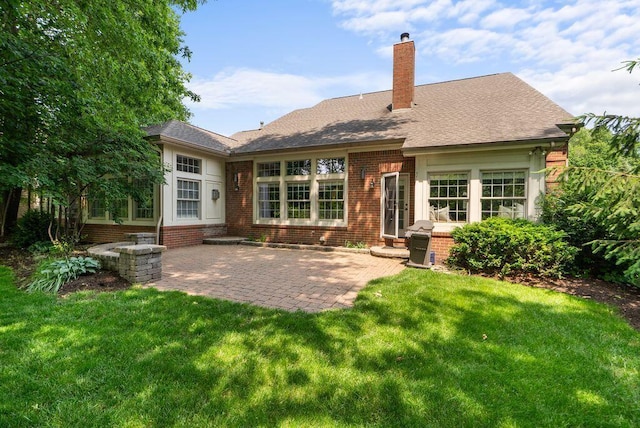 8467 Tartan Fields Dr, Dublin, OH 43017 - rear view of house with brick siding, a patio area, a yard, and a chimney
