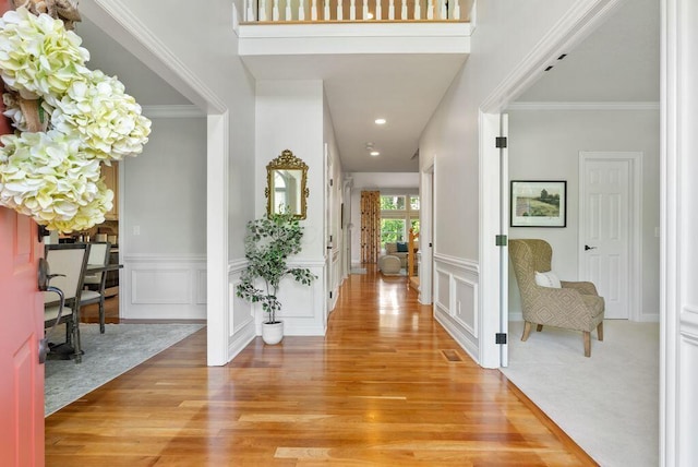 8467 Tartan Fields Dr, Dublin, OH 43017 - foyer entrance with light wood finished floors, a decorative wall, recessed lighting, a wainscoted wall, and crown molding