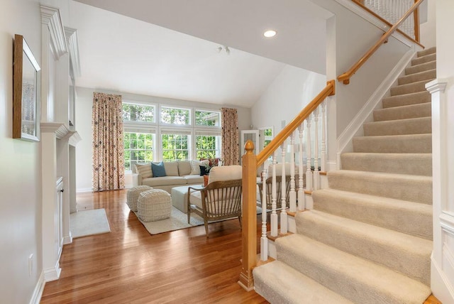 8467 Tartan Fields Dr, Dublin, OH 43017 - stairs featuring wood finished floors, recessed lighting, baseboards, and high vaulted ceiling