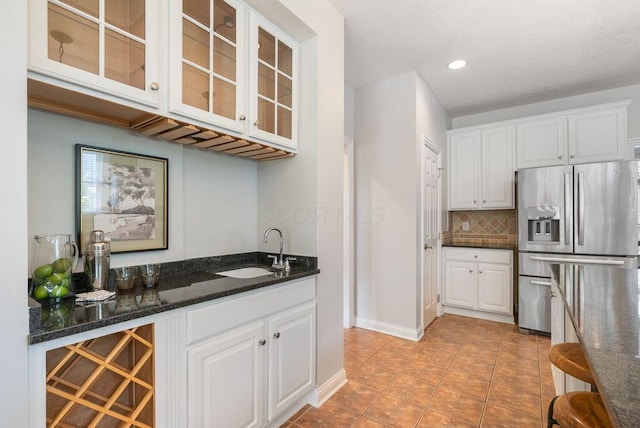8467 Tartan Fields Dr, Dublin, OH 43017 - indoor bar with stainless steel refrigerator with ice dispenser, tasteful backsplash, light tile patterned floors, recessed lighting, and baseboards
