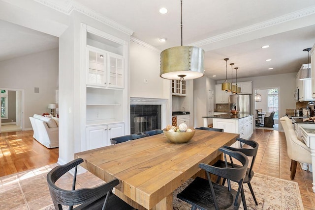 8467 Tartan Fields Dr, Dublin, OH 43017 - dining space with recessed lighting, built in features, a fireplace, baseboards, and crown molding
