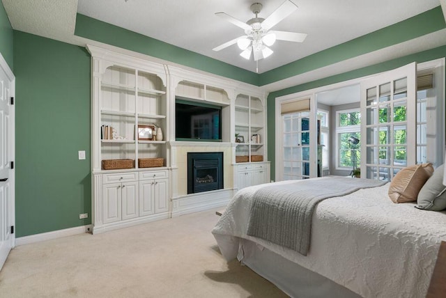 8467 Tartan Fields Dr, Dublin, OH 43017 - bedroom featuring a fireplace with raised hearth, baseboards, carpet, and a ceiling fan