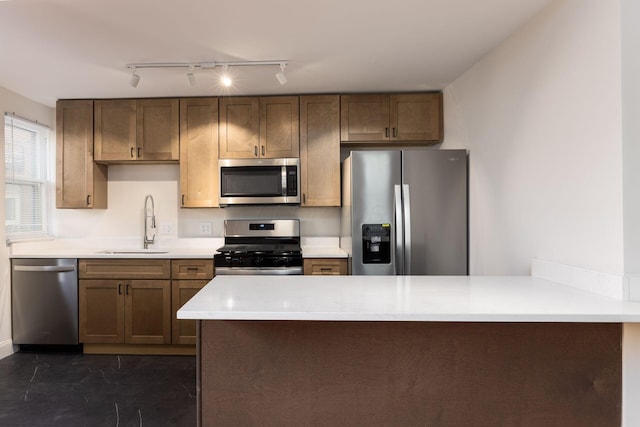 1210-1212 Dennison Ave, Columbus, OH 43201 - kitchen featuring stainless steel appliances, light countertops, a peninsula, and a sink