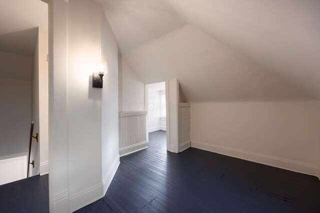 1210-1212 Dennison Ave, Columbus, OH 43201 - additional living space featuring vaulted ceiling, dark wood-style floors, and baseboards