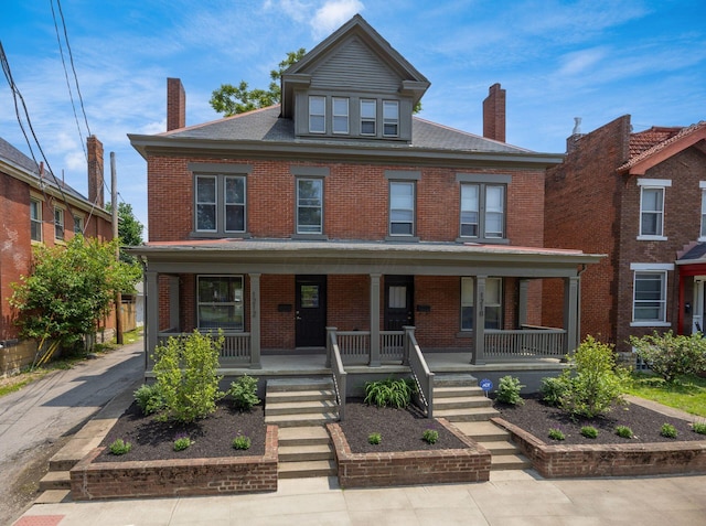 1210-1212 Dennison Ave, Columbus, OH 43201 - american foursquare style home featuring a chimney, brick siding, and covered porch