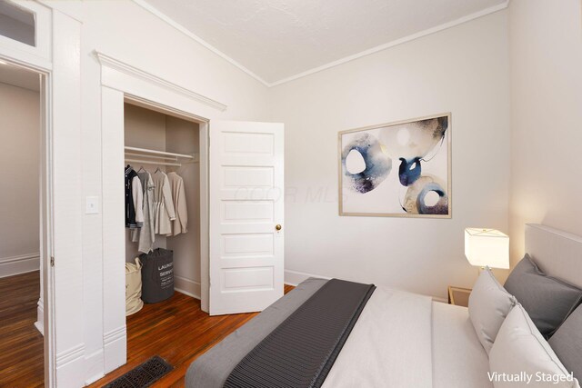 1210-1212 Dennison Ave, Columbus, OH 43201 - bedroom featuring crown molding, wood finished floors, a closet, and baseboards