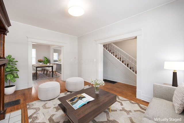 1210-1212 Dennison Ave, Columbus, OH 43201 - living area featuring stairs, wood finished floors, and baseboards