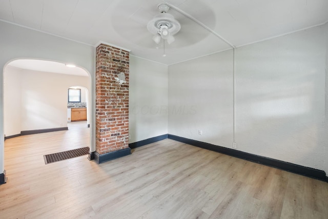 147 Schultz Ave, Columbus, OH 43222 - spare room featuring arched walkways, ceiling fan, and wood finished floors