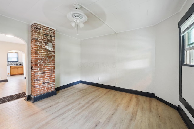 147 Schultz Ave, Columbus, OH 43222 - empty room with wood finished floors, arched walkways, a ceiling fan, and ornamental molding