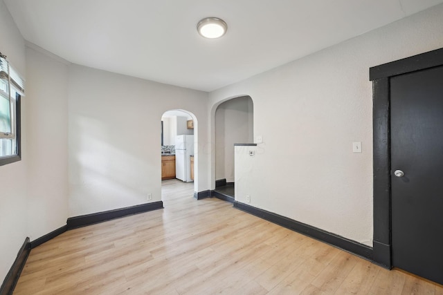 147 Schultz Ave, Columbus, OH 43222 - empty room featuring arched walkways and light wood-style flooring