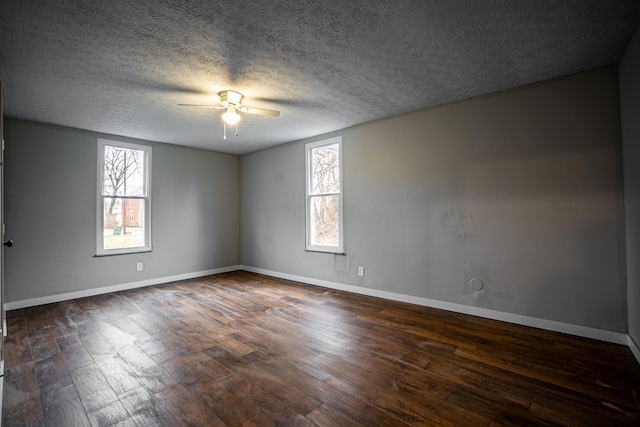 955 E Mound St, Columbus, OH 43205 - spare room featuring a ceiling fan, plenty of natural light, dark wood-style flooring, baseboards, and a textured ceiling