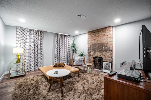 955 E Mound St, Columbus, OH 43205 - living room with a textured ceiling, wood finished floors, a brick fireplace, recessed lighting, and baseboards
