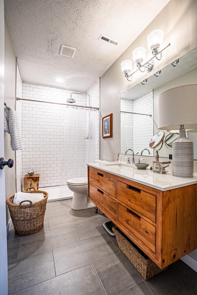 955 E Mound St, Columbus, OH 43205 - full bath with a shower stall, toilet, a textured ceiling, and vanity