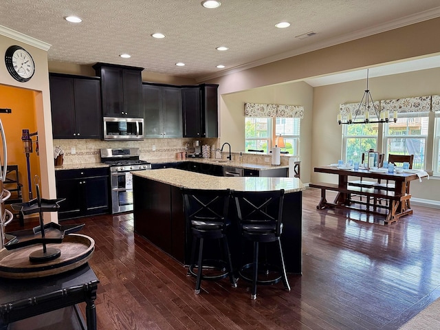 150 Shawnee Dr, Pickerington, OH 43147 - kitchen with appliances with stainless steel finishes, crown molding, a sink, dark cabinets, and tasteful backsplash