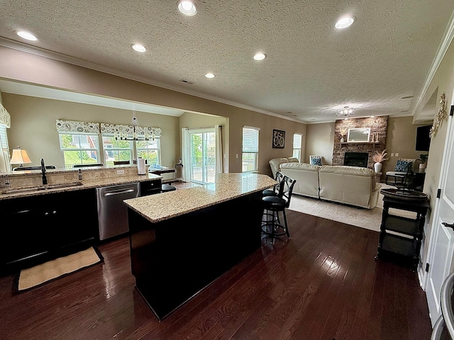 150 Shawnee Dr, Pickerington, OH 43147 - kitchen featuring dishwasher, ornamental molding, a sink, a kitchen breakfast bar, and a stone fireplace