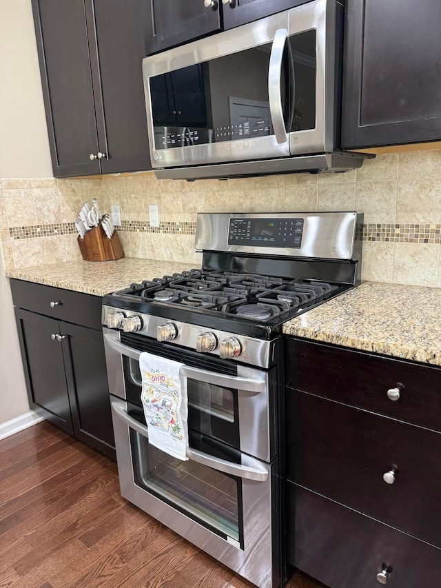 150 Shawnee Dr, Pickerington, OH 43147 - kitchen with stainless steel appliances, dark wood finished floors, light stone counters, and backsplash
