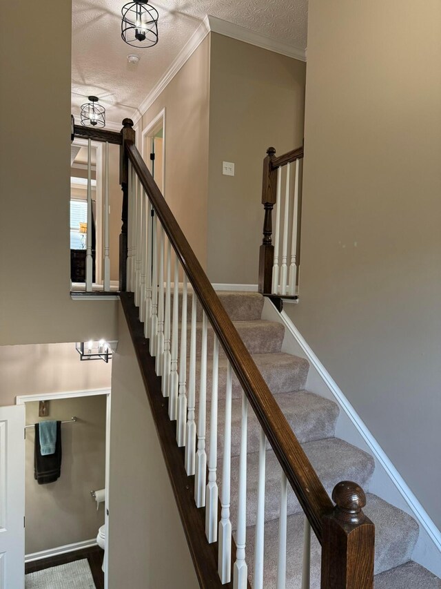 150 Shawnee Dr, Pickerington, OH 43147 - stairway featuring ornamental molding, a textured ceiling, and baseboards