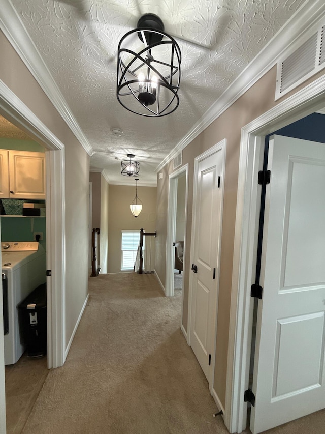 150 Shawnee Dr, Pickerington, OH 43147 - hall featuring light carpet, washer / clothes dryer, an upstairs landing, a chandelier, and a textured ceiling