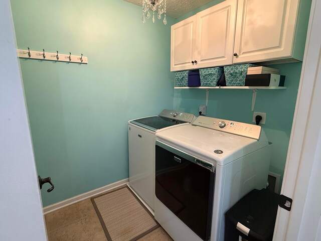 150 Shawnee Dr, Pickerington, OH 43147 - laundry area featuring cabinet space, washer and clothes dryer, baseboards, and a textured ceiling