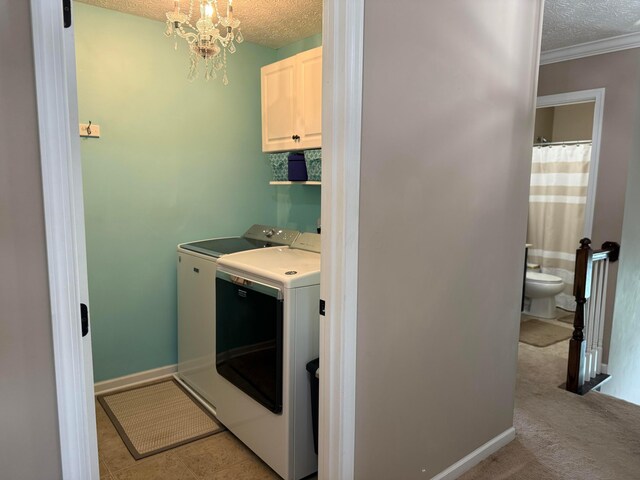 150 Shawnee Dr, Pickerington, OH 43147 - laundry room featuring a textured ceiling, washer and dryer, cabinet space, crown molding, and baseboards